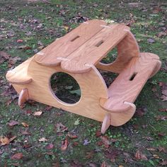 a wooden toy bench sitting in the grass