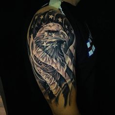 an eagle and american flag tattoo on the upper half of a man's arm