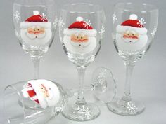 three wine glasses with santa hats on them