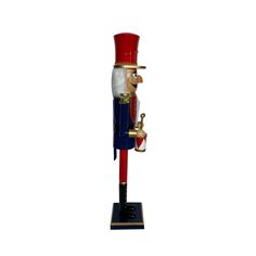 a toy nutcracker with a red, white and blue top