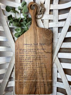 a wooden cutting board with writing on it