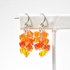 This listing is for one pair of crystal cluster earrings.  These lightweight earrings are made with 6mm bicone crystals in 3 shades of orange. They're so pretty in person, they really sparkle! As much as I try, the pictures just don't do them justice.  The earwires are stainless steel and they come with a clear back. I also have silver plated clip-on earrings and sterling silver earwires available. These earrings measure approximately 1.5 inches long, but the length may vary slightly if you upgr Cheap Orange Earrings For Crafting, Cheap Orange Bohemian Earrings, Cheap Orange Jewelry For Festivals, Cheap Orange Hypoallergenic Earrings, Cheap Orange Drop Earrings, Cheap Orange Earrings With Dangling Beads, Cheap Orange Pierced Earrings, Crystal Cluster Earrings, Orange Gradient