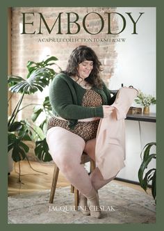 a woman sitting in a chair holding a pink bag