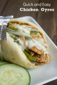 a chicken gyro sandwich on a plate with cucumber