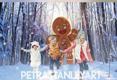 two girls and a boy are standing in the snow with a giant gingerbread man