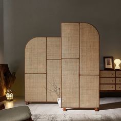 a room divider made out of wood and rattan with two vases on it