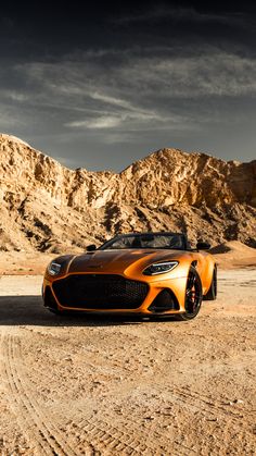 an orange sports car parked in the desert