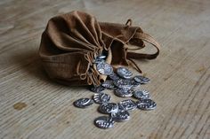 a bag full of coins sitting on top of a wooden table