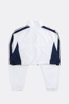 Reworked Adidas cropped windbreaker jacket with adjustable cord and toggle drawstring bottom. Sourced and reworked in CanadaMeasurementsSize: XLPit to Pit: 24.5"Arm: 28"Length: 17.5"Condition: Minor stains, good vintage conditionMaterial Composition: 100% NylonColour: White, Navy Sporty White Outerwear With Drawstring, Streetwear Long Sleeve Track Jacket With Drawstring, Long Sleeve Track Jacket With Drawstring For Streetwear, Athleisure Windbreaker With Drawstring For Streetwear, Athleisure Windbreaker With Functional Drawstring For Streetwear, Sporty Track Jacket With Drawstring For Streetwear, Sporty Fall Track Jacket With Drawstring, Long Sleeve Track Jacket With Functional Drawstring For Streetwear, Urban Windbreaker With Drawstring For Streetwear