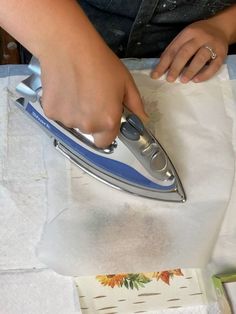 a woman ironing fabric with an electric iron