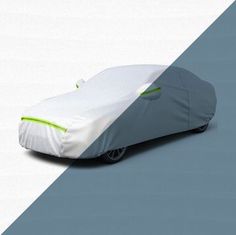 a car covered in a white and green cover sitting on top of a gray floor