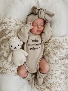 a baby is laying down next to a teddy bear