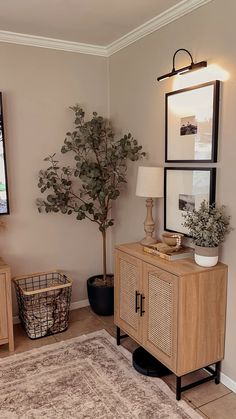 a living room with a rug, table and television on the wall in front of it