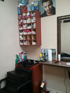 a hair dresser and chair in a room with pictures on the wall above it, along with other items