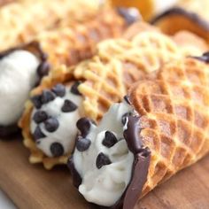 waffles with chocolate chips and whipped cream on them sitting on a cutting board