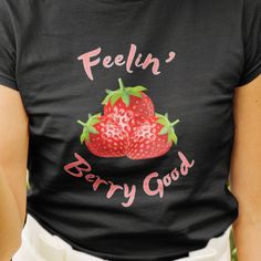 "This comfortable and flattering strawberry aesthetic t-shirt will be your new favorite! Features a vivid strawberry print with a positive \"Feelin' Berry Good\" message. A perfect gift for gardeners, plant moms and your favorite botanical enthusiasts. Surprise the fruit lover in your life with this soft and light summer shirt. Printed on soft and cozy Gildan Unisex Softstyle shirts or Bella+Canvas Women's shirts. Gildan Unisex Softstyle Shirts * 100% Ring-spun cotton * Fabric weight: 4.5 oz * Runs true to size * Eurofit Bella+Canvas Women's Shirts * 100% airlume combed and ringspun cotton (fiber content may vary for different colors) * Fabric weight: 4.2 oz * Slim fit with longer body length * Runs smaller than usual Care Instructions * Wash in warm water, max 40C or 105F * Do not bleach Trendy Text Print Top As Gift, Graphic Tee With Slogan As A Gift, Trendy Graphic Print Shirt As Gift, Trendy Slogan Tops For Gifts, Relaxed Fit Slogan Top As Gift, Trendy Graphic Print T-shirt For Gift, Graphic Tee With Slogan As Gift, Summer Slogan Top As Gift, Trendy Screen Print T-shirt For Gifts