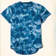 Blue Tye Dye Hollister T-Shirt With Logo Blue Cotton T-shirt For Summer, Washed Blue Graphic Print Short Sleeve Top, Short Sleeve Washed Blue Top With Graphic Print, Washed Blue Graphic Print Crew Neck Top, Washed Blue Crew Neck Top With Graphic Print, Washed Blue Crew Neck Top For Summer, Blue Relaxed Fit Graphic Tee, Casual Washed Blue Short Sleeve Tops, Blue Short Sleeve Tops With Relaxed Fit