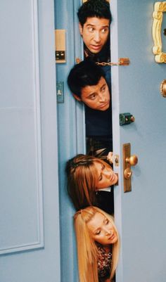 the cast of friends hanging out in front of a blue door with their heads sticking out