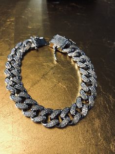 FAST SHIPPING!*TRUSTED SELLER**2300+ TRANSACTIONS* -Will be shipped through USPS with First Class Mail that includes tracking so you'll get it quick! -Don't confuse this with those cheap low quality cuban links that have glued in stones. -Premium 14k white gold OR yellow gold plated diamond cuban link Bracelet! -Plating is PVD which is the highest quality. -Stones are high quality VVS simulated lab diamonds(CZ)! Hand prong set and not glued in like the cheap ones! -Very nice box clasp! -12mm wid Silver Diamond Chain Bracelet With Pave Setting, Luxury Cuban Link Bracelet With Bling, Luxury Bling Cuban Link Bracelets, Luxury Cuban Link Bracelet In Diamond White Cubic Zirconia, Luxury Cuban Link Bracelet In Diamond White, Luxury Iced-out Cubic Zirconia Chain Bracelet, Luxury Silver Cuban Link Bracelet With Diamond Accents, Cuban Link White Gold Chain Bracelet With Diamond Accents, Iced Out Diamond Bracelet