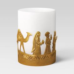 a white and gold coffee mug with an image of the nativity scene on it