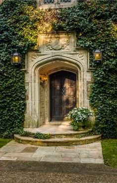 an old building with ivy growing on it's walls and door to the entrance