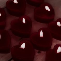 many heart shaped candles sitting on top of each other