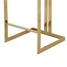 a gold metal and wood side table with an open triangle design on the top, against a white background