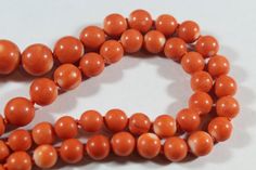 -Vintage 14k Gold Natural Japanese Momo Coral with Raw Diamond Necklace -Total length: 18.5 in -Coral size: 6.15 mm ~ 12.4 mm -Total weight: 36.3 g -Marked 14k Vintage 8mm Beads Jewelry For Formal Occasions, Vintage Formal Jewelry With 8mm Beads, Formal Vintage Jewelry With 8mm Beads, Classic Orange Necklace For Formal Occasions, Classic Orange Necklaces For Formal Occasions, Orange Classic Formal Necklaces, Orange Classic Formal Necklace, Formal Orange Round Bead Jewelry, Formal Orange Single Strand Necklace