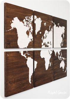 three pieces of wood with the world map painted on one side and white paint on the other