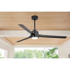 a ceiling fan in a living room with wood paneling on the ceiling and windows