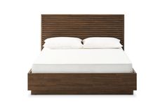 a bed with white sheets and pillows on top of it's headboard, in front of a white background