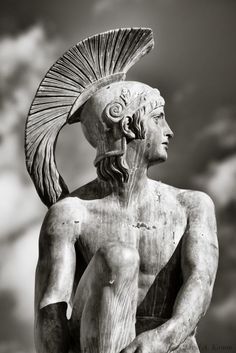 an ancient statue is shown against a cloudy sky