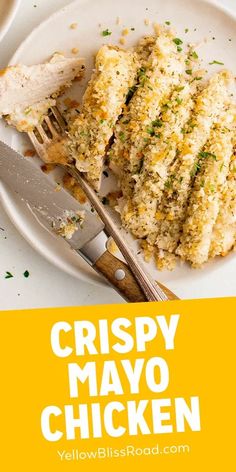 crispy mayo chicken on a white plate with a fork and knife next to it