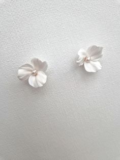 These lovely floral stud earrings are handcrafted with delicate polymer clay flowers and adorned with freshwater pearls. They are attached to sterling silver or gold-filled studs for a touch of elegance. Sent beautifully packaged in Medze Bride gift box. As 'Dreamy White' earrings are made to order as well due to hygienic reasons I cannot accept refunds/exchanges. But if you have any problems with your order please email me and I'll be happy to help you. Handle with care due to the handcrafted n Wedding Earrings Bride, Dreamy Whites, White Studs, Floral Studs, Bride Earrings, Polymer Clay Flowers, Bride Gift, Clay Flowers, Wedding Jewelry Earrings