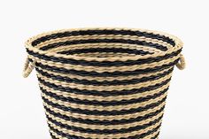 a black and white striped basket with handles