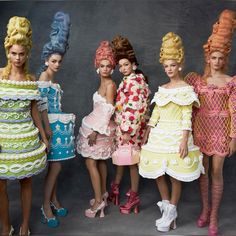 several models in colorful dresses and high heels