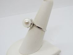 Vintage Sterling Silver White Pearl Ring...Marked 925...Total of weights 3.5grams... Size 6...Measure of stone center 10.2MM...It's in very good condition. Luxury Vintage Silver Pearl Ring, Handmade Vintage Pearl Ring In Sterling Silver, White Sterling Silver Hallmarked Pearl Ring, Vintage Adjustable Silver Pearl Ring, Vintage Hallmarked Silver Pearl Ring, White Pearl Ring, Micro Pave Ring, Eternity Band Ring, Sterling Silver Flowers