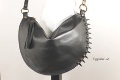 Spiky Halfmoon. Mini bag. Italian leather handbag of first choice. Black color. The peculiarity of this bag are the applied leather tips that make punk an extremely classic accessory. Double seams everywhere. The measurements are: height about 24 cm (about 9,44 inches), width zipper side about 38 cm (about 14,9 inches). The strap can be worn in two sizes: in its length or shortened by passing the hook into the opposite ring and attach it in the starting ring. The length of the strap is basic abo Gothic Black Shoulder Bag For Festivals, Punk Style Party Bag With Rivets, Punk Party Bag With Rivets, Punk Style Party Bags With Rivets, Edgy Party Bags With Rivets, Gothic Leather Bag For Everyday Use, Punk Party Shoulder Bag With Rivets, Punk Leather Bag For Festivals, Punk Style Leather Bags For Daily Use