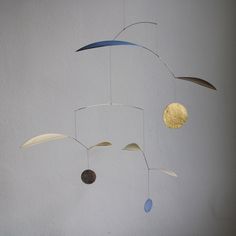 an image of a mobile that is hanging from the ceiling with circles and shapes on it