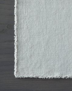 a white rug with fringes on top of it