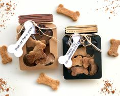 two jars filled with dog treats on top of a table