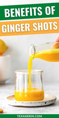 a person pouring orange juice into a small glass jar with the words benefits of ginger shots