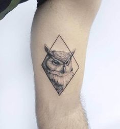 an owl tattoo on the left thigh with geometric shapes and black lines around its head