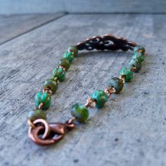 "This bracelet is the perfect match to several of the dark green items in my shop (with more to come). I love this lightweight copper bracelet with the scroll design accent. The beads on this bracelet are 3x5mm, and 4mm melon beads. The beads are small and delicate. I put a slight curve in the copper connector. It makes it lay comfortably on the wrist. This bracelet is offered in a variety of sizes, so the number of beads may be slightly different than what is pictured. If you are ordering for a Green Bohemian Bracelets With Patina, Green Patina Bracelet As A Gift, Green Patina Bracelet As Gift, Green Bracelet With Patina As Gift, Green Bracelets With Patina As Gift, Short Beaded Necklace, Green Items, Teal Earrings, Winter Earrings