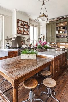 an old fashioned kitchen with wooden floors and green cabinets