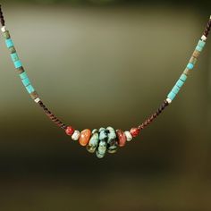 With an eye for color and style, Thailand's Sareeyakarn puts together a beautiful collection of gemstones for the design of this necklace. She crafts the necklace by hand with a dark brown cord tying macramé knots and adding calcite dyed turquoise, jasper and silver beads. Reconstituted turquoise accentuates the harmony of colors on this Bohemian necklace with a sterling clasp. materials: 950 silver, jasper, reconstituted turquoise, dyed calcite, nylon cord and 925 sterling silver clasp S-hook o Cheap Handmade Turquoise Beaded Necklaces, Cheap Southwestern Style Multicolor Necklaces, Multi Gemstone Necklace, Afrikaanse Mode, Gemstone Beaded Necklace, Bead Necklaces, Necklace Ideas, Popular Jewelry, Homemade Jewelry