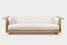 a white couch sitting on top of a wooden frame