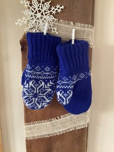 Warm and wonderful these sweater mittens are so warm. They are made with a royal blue sweater with a white snowflake design. These mittens are made with one sweater. This is a handmade item.  They are lined with a white polar fleece.  These mittens are adult-medium . They measure 9 inches from the cuff to the fingertips and 4 inches across the top of the hand or 8 inches around the hand.  I hand sew around the cuff of every pair of mittens to insure they stay together very nicely.  They are hand Royal Blue Sweater, Sweater Mittens, Recycled Sweater, Snowflake Design, White Snowflake, Snowflake Designs, Merino Wool Sweater, Blue Sweater, Polar Fleece