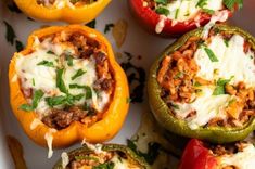 several stuffed peppers with meat and cheese on them