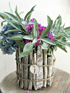 a basket filled with purple flowers on top of a wooden table